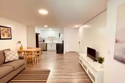 a living room with a couch and a table at Unit #201 Cozy Mountain View 1BR in DT in Canmore