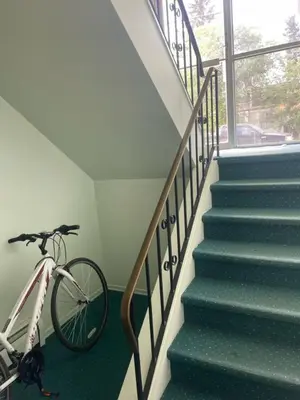 a bike is parked next to a staircase at One Bedroom Main floor Apartment in Camrose