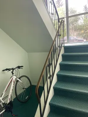 a bike parked next to a staircase in a house at Stunning 1 Bedroom Apartment in Camrose