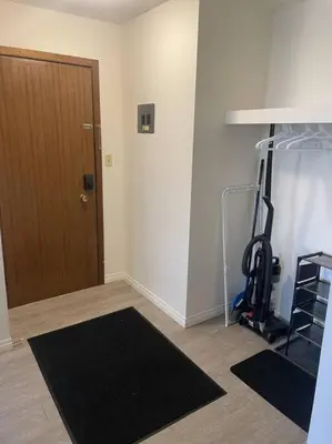a room with a room with a treadmill and a door at Stunning 1 Bedroom Apartment in Camrose