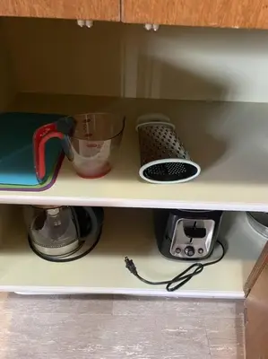 a shelf with a blender and other kitchen items at Stunning 1 Bedroom Apartment in Camrose