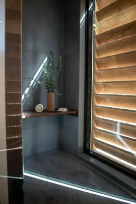 a hallway with a staircase and a plant on a shelf at Refuge Bay's Aqua Tiny Home - Luxury Off Grid Escape in Cherhill