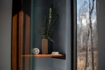 a plant sitting on a shelf next to a window at Refuge Bay's Aqua Tiny Home - Luxury Off Grid Escape in Cherhill