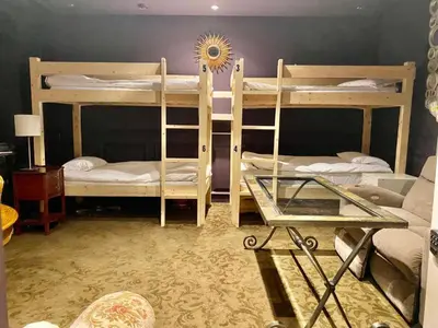 a room with two bunk beds and a glass table at Vancouver Airport guesthouse in Vancouver