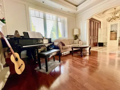 a living room with a piano and a couch at Vancouver Airport guesthouse in Vancouver