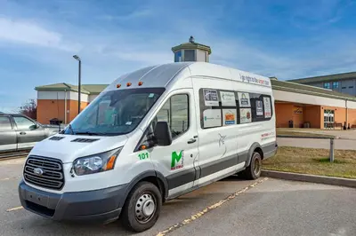 a small white van parked in a parking lot at Quality Inn & Suites Edmonton International Airport in Leduc