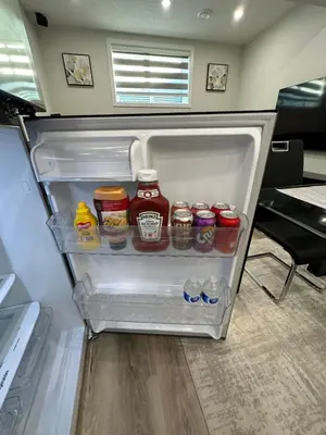 an open refrigerator filled with lots of condiments at 2 Bedroom 2 Washrooms Brand New Beautiful & Cozy Suite in Calgary