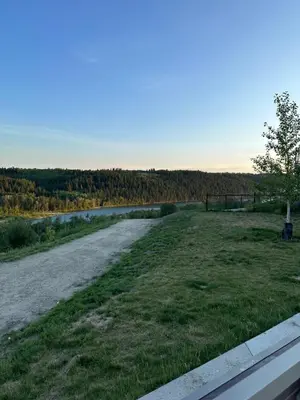 a road in a field next to a river at 2 Bedroom 2 Washrooms Brand New Beautiful & Cozy Suite in Calgary
