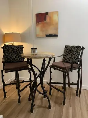 a table and two chairs with a table and a lamp at Country studio pet friendly in Port Alberni