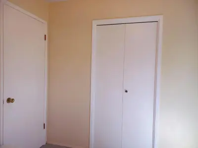 two white closets are in a room with a wall at private room with queen bed in richmond 202 in Richmond