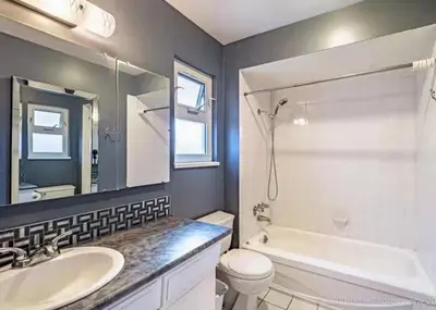 a bathroom with a sink and a tub and a toilet at private room with queen bed in richmond 202 in Richmond