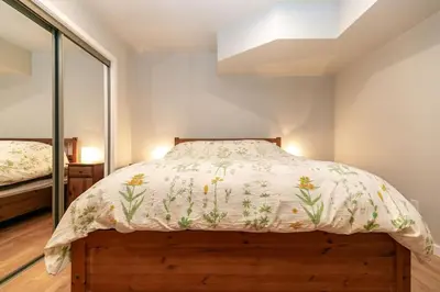 a bedroom with a bed with a comforter on it at Lovely 1 Bedroom Suite Near Town in Victoria