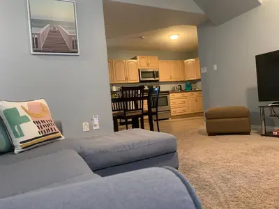 a living room with a couch and a kitchen at Cozy Basement Suite close to Downtown,Edmonton in Edmonton