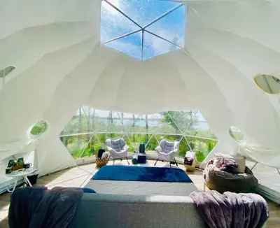 a bedroom with a bed in a tent at Refuge Bay's Ignis Dome - Luxury Off Grid Escape in Cherhill