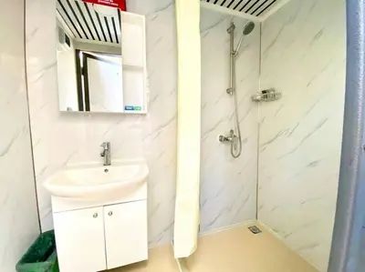 a white bathroom with a sink and a shower at Refuge Bay's Ignis Dome - Luxury Off Grid Escape in Cherhill