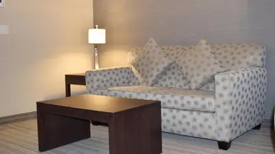 a living room with a couch and a table at Holiday Inn Express Golden-Kicking Horse by IHG in Golden