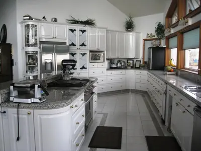 a kitchen with white cabinets and a counter top at Rolling Hills Country Resort Bed and Breakfast in Three Hills
