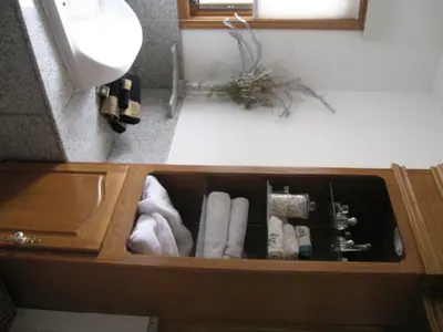 a drawer in a bathroom with towels in it at Rolling Hills Country Resort Bed and Breakfast in Three Hills