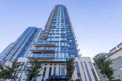 a tall building with trees in front of it at LUXURY Downtown Sunset Getaway - Your Home Away From Home - Fully Stocked Kitchen, Gym, Balcony, FREE PARKING in Calgary