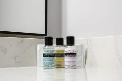 three bottles of moisturizers sitting on a bathroom counter at Copper Mountain Inn and Suites in Princeton