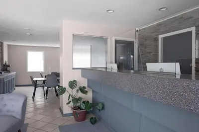 a kitchen with a counter and a dining room at Copper Mountain Inn and Suites in Princeton