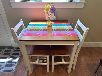 a table with two chairs and a vase with flowers on it at Separate entry sweet home in Victoria