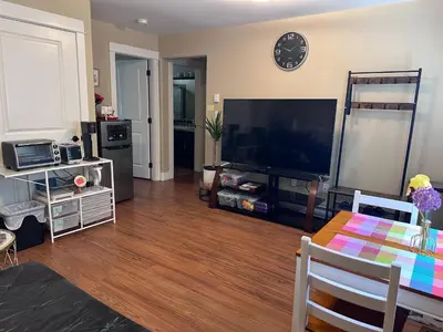 a living room with a large flat screen tv at Separate entry sweet home in Victoria