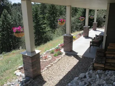 a porch with potted plants on the columns of a house at Okanagan Lake Sunrise BB in Vernon
