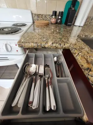 a kitchen with a sink with utensils in it at Moonlight Suite in Vancouver