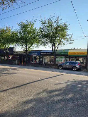 a car parked in front of a store on a street at Moonlight Suite in Vancouver