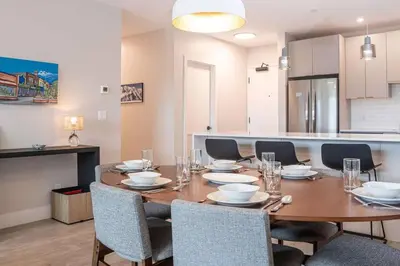 a dining room with a wooden table and chairs at Northern Exposure by Revelstoke Vacations in Revelstoke