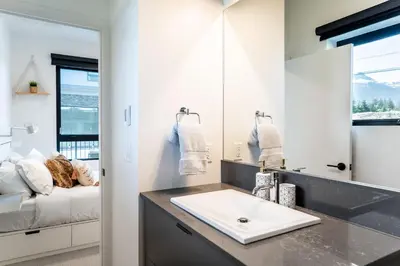 a bathroom with a sink and a mirror at Summit Place - Condo With Mountain Views in Revelstoke