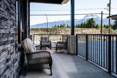 a balcony with chairs and a view of mountains at Summit Place - Condo With Mountain Views in Revelstoke