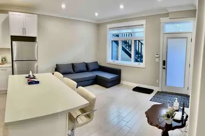 a living room with a couch and a table at \u6e29\u897f\u6c11\u5bbf Vancouver West Quiet Home in Vancouver