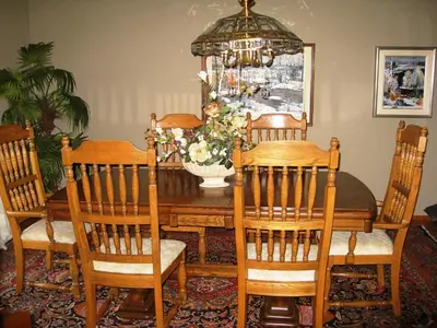 a dining room table with chairs and a vase of flowers at McDougall Lane Bed & Breakfast in Drumheller