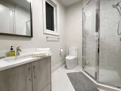 a bathroom with a shower and a toilet and a sink at Rose Garden Vacation Studio in Richmond