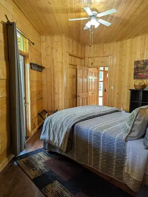 a bedroom with a bed and a ceiling fan at Sundance Country Lodge B&B in Marlboro