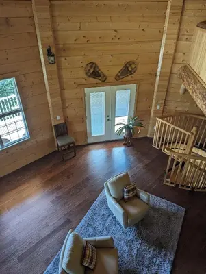 a living room with a couch and chairs in a cabin at Sundance Country Lodge B&B in Marlboro