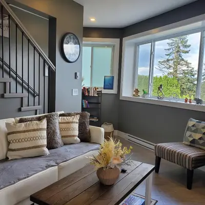 a living room with a couch and a table at Garden House Near Heritage Park-Coliseum -HWY 1-Fishing-Cultus Lake in Chilliwack