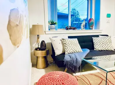 a living room with a couch and a window at Charming 1BR near Metrotown DT Burnaby/ Vancouver in Vancouver