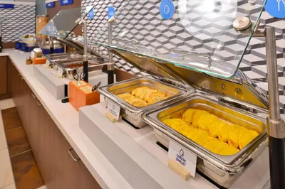 a buffet line with trays of food on display at Holiday Inn Express Fort St John by IHG in Fort Saint John