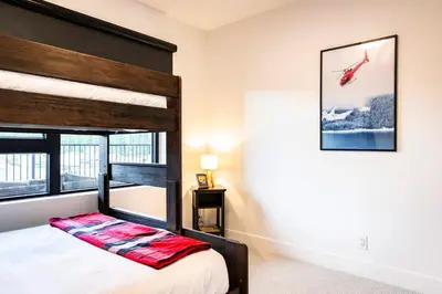a bedroom with a bunk bed and a window at The Shred Shack - Stylish Revelstoke Condo in Revelstoke