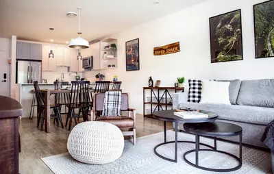 a living room with a couch and a table at The Shred Shack - Stylish Revelstoke Condo in Revelstoke