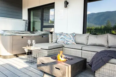 a living room with a couch and a fire pit at The Shred Shack - Stylish Revelstoke Condo in Revelstoke