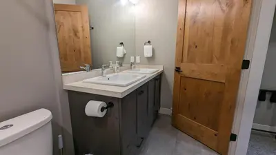 a bathroom with a sink and a mirror and a toilet at Echo Landing #13 condo in Sun Peaks