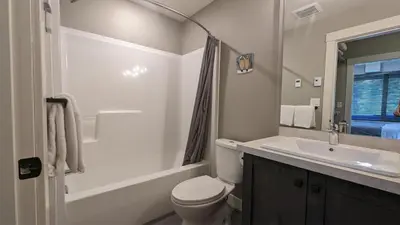 a bathroom with a toilet and a sink and a shower at Echo Landing #13 condo in Sun Peaks