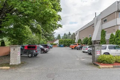 a parking lot with cars parked next to a building at Wanderlust Studio Suite with Private Patio in Harrison Hot Springs
