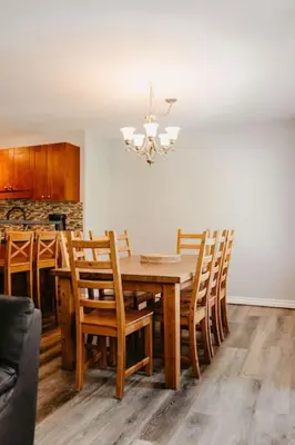 a dining room with a wooden table and chairs at Trailblazers Retreat 3 Bed with Family Games Room in Big White
