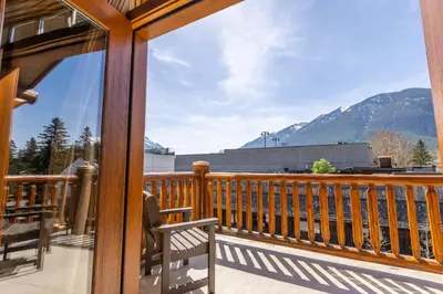 a balcony with a view of the mountains at Brewster Mountain Lodge in Banff