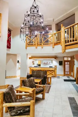 a large living room with a chandelier at Brewster Mountain Lodge in Banff